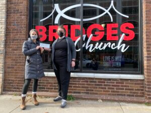 Pastor Anna-Lisa Hunter of Bridges Church in La Crosse presents a check for the Black Empowerment Fund to La Crosse Community Foundation Executive Director Jamie Schloegel