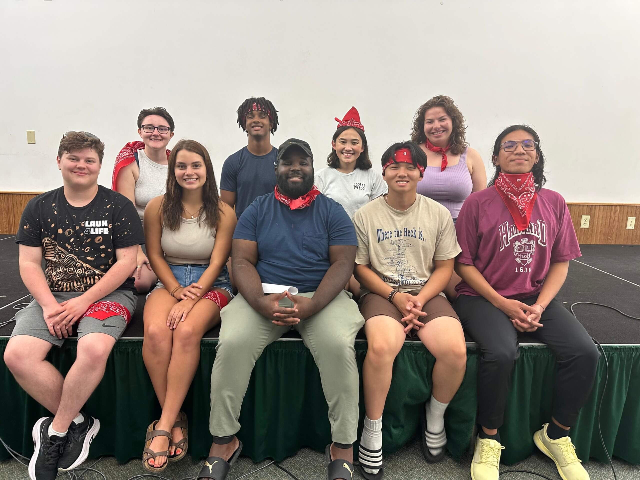 Reg Hawkins poses for photo surrounded by eight student staff members at residence life training.