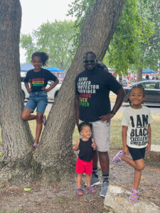 Walfsty Pierre with his three children volunteering at Juneteenth event in La Crosse