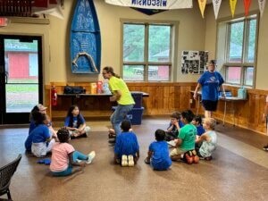 children enjoying indoor pop-up camp activity as it rains outside