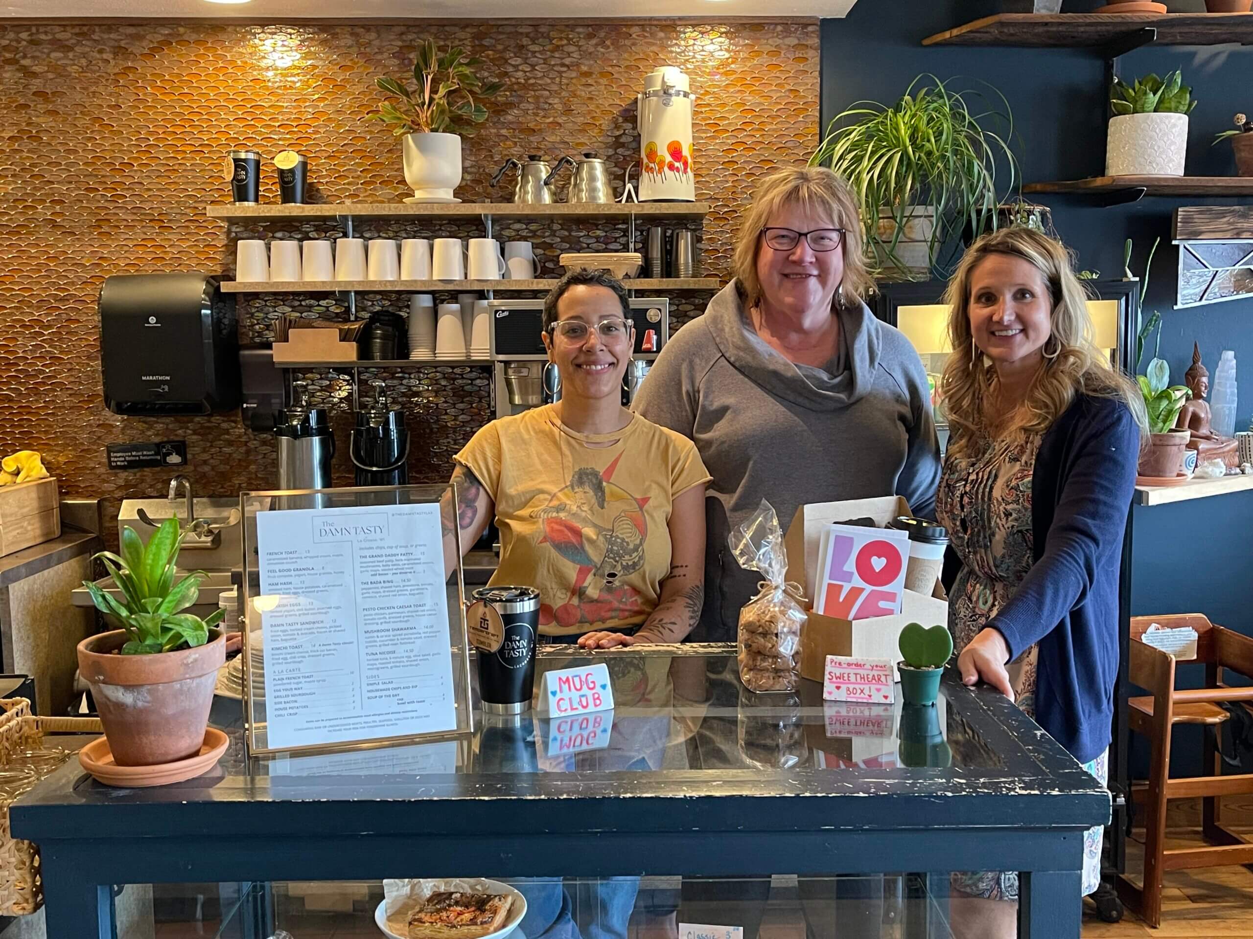 Kara Schuster of WWBIC poses with Mary Kessons of The Women's Fund and The Damn Tasty owner Nicole Elliott at Elliott's restaurant.