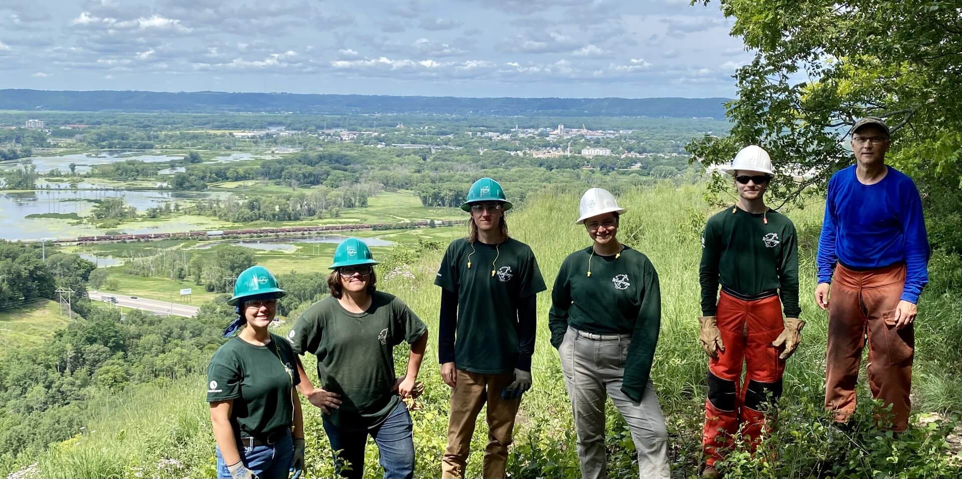 Friends of the Blufflands' Mike O'Brien poses with a WisCorps crew on Mathy Bluff Prairie.