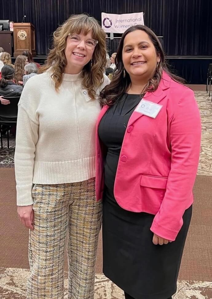 The Women's Fund Executive Director Sarah Ellingson poses with panelist and former Women's Fund board member Dina Zavala at the 2023 International Women's Day Event.