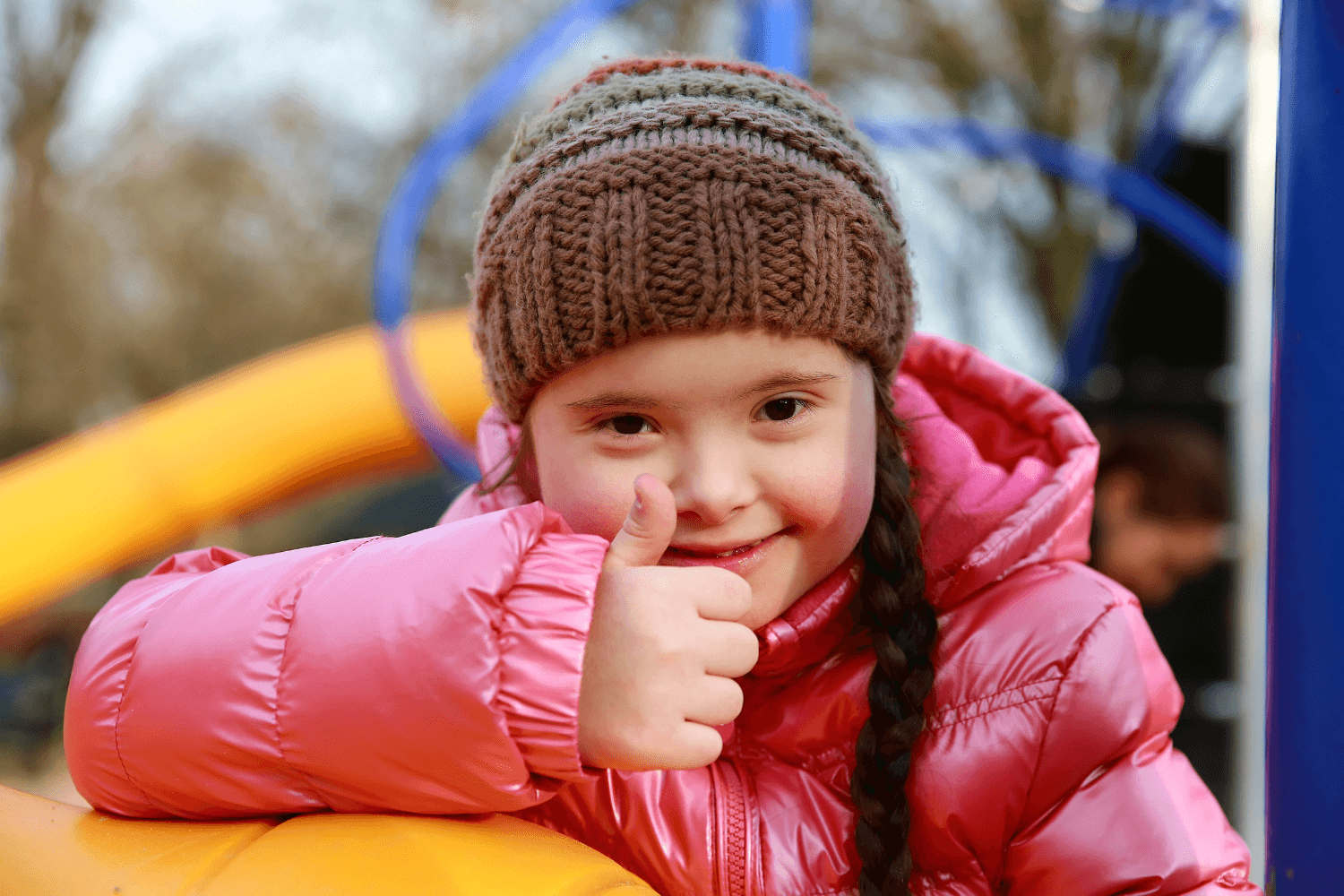 Local nonprofit solutions include an accessible playground, as depicted here with a child with Down syndrome on playground.